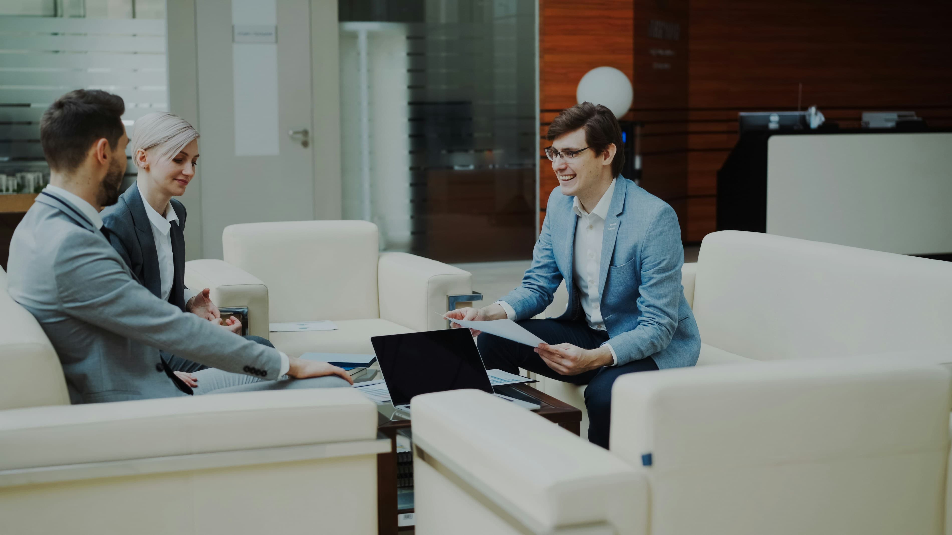 A business team meeting with a client in a modern office